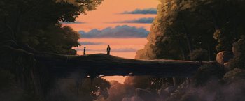 Movie still from “Funan” (2018), directed by Denis Do – Two people are standing on a hill overlooking a forest; Extreme Wide shot, Low angle