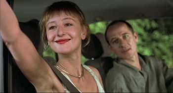 Movie still from “Funny Games” (1997), directed by Michael Haneke – A man and a woman sitting in the back of a car; Close Up shot, Low angle