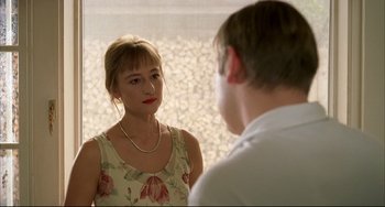 Movie still from “Funny Games” (1997), directed by Michael Haneke – A man and a woman looking at one another in the mirror; Close Up shot, Over the shoulder angle