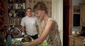 Movie still from “Funny Games” (1997), directed by Michael Haneke – A woman and a man in a kitchen preparing food; Medium shot, Over the shoulder angle