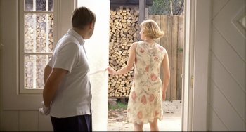 Movie still from “Funny Games” (1997), directed by Michael Haneke – A man and a woman standing in front of an open door; Medium shot, Over the shoulder angle