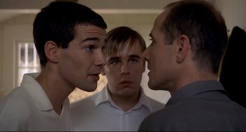 Movie still from “Funny Games” (1997), directed by Michael Haneke – A group of men standing next to each other in front of each other; Close Up shot, Over the shoulder angle
