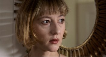 Movie still from “Funny Games” (1997), directed by Michael Haneke – A person with short blonde hair; Close Up shot, Low angle