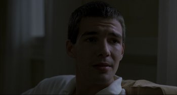 Movie still from “Funny Games” (1997), directed by Michael Haneke – A person wearing a white shirt; Close Up shot, Over the shoulder angle