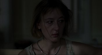 Movie still from “Funny Games” (1997), directed by Michael Haneke – A woman with a necklace is looking at the camera; Close Up shot, Over the shoulder angle