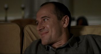 Movie still from “Funny Games” (1997), directed by Michael Haneke – A person sitting in a chair; Close Up shot, Low angle