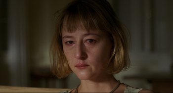 Movie still from “Funny Games” (1997), directed by Michael Haneke – A person with short blonde hair; Close Up shot, High angle