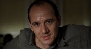 Movie still from “Funny Games” (1997), directed by Michael Haneke – A person with a beard; Close Up shot, Low angle