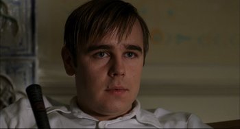 Movie still from “Funny Games” (1997), directed by Michael Haneke – A person wearing a white shirt; Close Up shot, Low angle