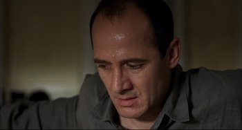 Movie still from “Funny Games” (1997), directed by Michael Haneke – A person looking down at his face; Close Up shot, Low angle