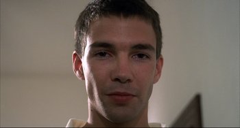 Movie still from “Funny Games” (1997), directed by Michael Haneke – A young man's face; Close Up shot, Low angle