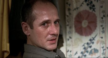 Movie still from “Funny Games” (1997), directed by Michael Haneke – A person wearing a shirt; Close Up shot, Low angle