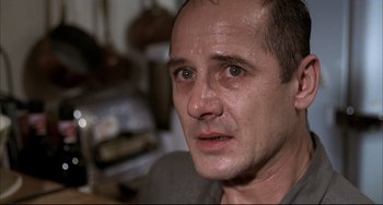 Movie still from “Funny Games” (1997), directed by Michael Haneke – A man's face with water on his face; Close Up shot, Low angle