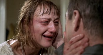 Movie still from “Funny Games” (1997), directed by Michael Haneke – A woman crying while holding her face to her ear; Close Up shot, Over the shoulder angle