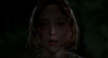 Movie still from “Funny Games” (1997), directed by Michael Haneke – A young girl is looking into the camera; Close Up shot, Low angle