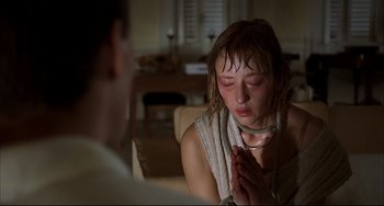 Movie still from “Funny Games” (1997), directed by Michael Haneke – A young woman is crying in front of a man; Close Up shot, High angle
