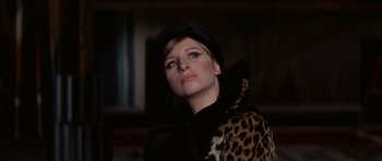 Movie still from “Funny Girl” (1968), directed by William Wyler – A woman wearing a leopard print coat and a black hat; Close Up shot, Low angle
