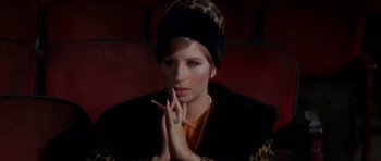 Movie still from “Funny Girl” (1968), directed by William Wyler – A woman sitting in a chair with a cigarette in her mouth; Close Up shot, High angle