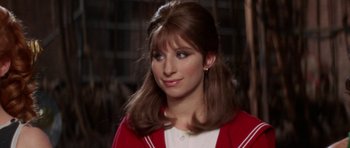 Movie still from “Funny Girl” (1968), directed by William Wyler – A young woman in a white shirt and a red jacket; Close Up shot, Over the shoulder angle