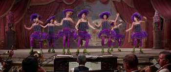 Movie still from “Funny Girl” (1968), directed by William Wyler – A group of women in purple outfits on a stage; Wide shot, Low angle