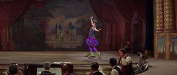 Movie still from “Funny Girl” (1968), directed by William Wyler – A woman in a purple dress is on a skateboard; Wide shot, Low angle