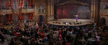 Movie still from “Funny Girl” (1968), directed by William Wyler – A crowd of people sitting and standing around a stage; Extreme Wide shot, High angle