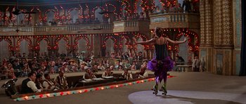 Movie still from “Funny Girl” (1968), directed by William Wyler – A woman on a roller skates in a circus; Extreme Wide shot, Low angle