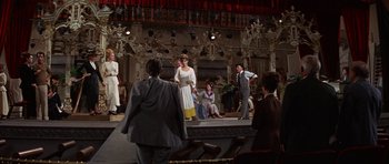 Movie still from “Funny Girl” (1968), directed by William Wyler – A group of people on a stage in a theater; Wide shot, Low angle
