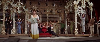 Movie still from “Funny Girl” (1968), directed by William Wyler – A group of people sitting and standing on a stage; Wide shot, High angle