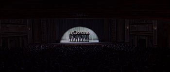 Movie still from “Funny Girl” (1968), directed by William Wyler – A group of men standing in front of a curtain; Extreme Wide shot, High angle
