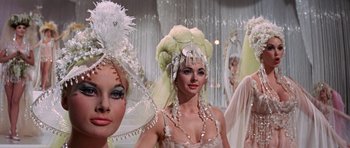 Movie still from “Funny Girl” (1968), directed by William Wyler – A group of women in fancy hats standing next to each other; Close Up shot, Low angle