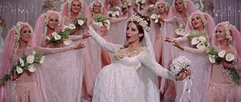Movie still from “Funny Girl” (1968), directed by William Wyler – A woman dressed as a bride in front of a bunch of other women; Medium shot, High angle