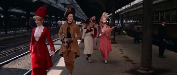 Movie still from “Funny Girl” (1968), directed by William Wyler – A group of women walking down a train platform; Wide shot, High angle