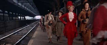 Movie still from “Funny Girl” (1968), directed by William Wyler – A group of women walking down a train platform; Wide shot, Low angle