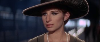 Movie still from “Funny Girl” (1968), directed by William Wyler – A person wearing a hat; Close Up shot, Over the shoulder angle