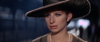 Movie still from “Funny Girl” (1968), directed by William Wyler – A person wearing a hat; Close Up shot, Over the shoulder angle