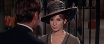 Movie still from “Funny Girl” (1968), directed by William Wyler – A woman wearing a hat and a necklace; Close Up shot, Over the shoulder angle