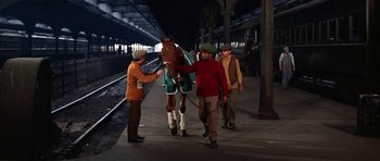 Movie still from “Funny Girl” (1968), directed by William Wyler – Three men and a horse on a train platform; Wide shot, Low angle
