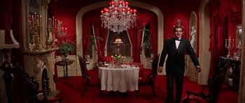 Movie still from “Funny Girl” (1968), directed by William Wyler – A dining room decorated in red and white; Wide shot, Low angle