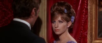 Movie still from “Funny Girl” (1968), directed by William Wyler – A young woman with long brown hair wearing a purple dress; Close Up shot, Over the shoulder angle