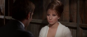 Movie still from “Funny Girl” (1968), directed by William Wyler – A woman in a white dress is talking to a man in a white suit; Close Up shot, Over the shoulder angle