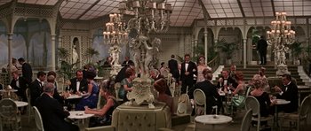Movie still from “Funny Girl” (1968), directed by William Wyler – A group of people standing around in a room; Wide shot, High angle