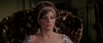Movie still from “Funny Girl” (1968), directed by William Wyler – A person sitting in a chair wearing a tiara; Close Up shot, Over the shoulder angle