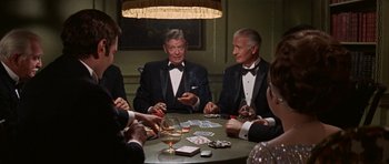 Movie still from “Funny Girl” (1968), directed by William Wyler – A group of men sitting around a table playing cards; Medium shot, High angle
