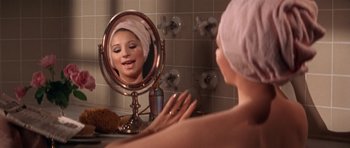 Movie still from “Funny Girl” (1968), directed by William Wyler – A woman with a towel wrapped around her head looking in a mirror; Close Up shot, High angle