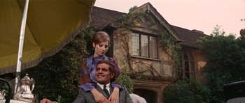 Movie still from “Funny Girl” (1968), directed by William Wyler – A man and a woman in front of an old house; Medium shot, Low angle