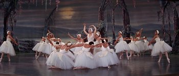 Movie still from “Funny Girl” (1968), directed by William Wyler – A group of ballerinas in white tutus on a stage; Wide shot, High angle