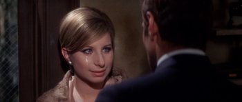 Movie still from “Funny Girl” (1968), directed by William Wyler – A young woman with tears in her eyes and a man in a suit looking at her; Close Up shot, Over the shoulder angle