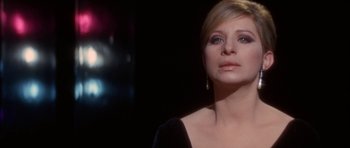 Movie still from “Funny Girl” (1968), directed by William Wyler – A person wearing a black dress; Close Up shot, Over the shoulder angle