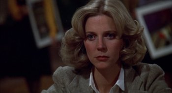 Movie still from “Futureworld” (1976), directed by Richard T. Heffron – A person wearing a suit and tie; Close Up shot, Over the shoulder angle